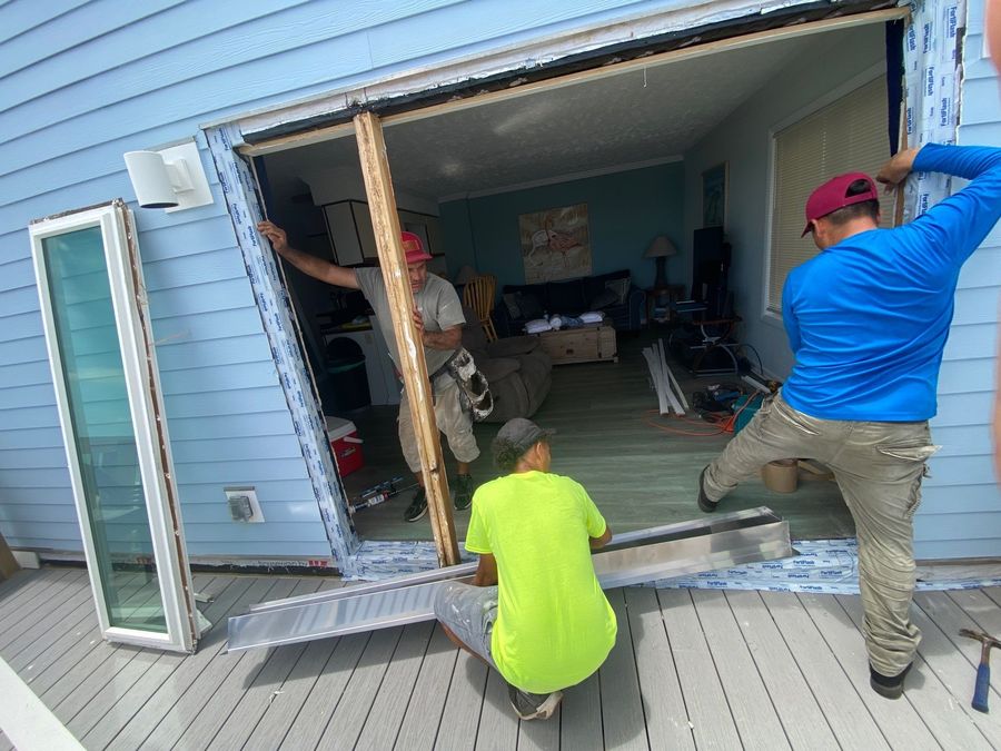 Chapman's crew installing a large window on a coastal commercial building